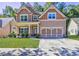 Two-story house with a large front yard, attached garage, and neutral color scheme at 4233 Creekrun Cir, Buford, GA 30519