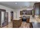 Modern kitchen with stainless steel appliances, granite countertops, a center island, and dark cabinetry at 4233 Creekrun Cir, Buford, GA 30519
