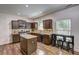 Spacious kitchen featuring dark wood cabinets, granite counters, an island, and stainless steel appliances at 4233 Creekrun Cir, Buford, GA 30519