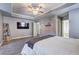 Spacious main bedroom with a decorative ceiling, a large bed, neutral walls, and carpeted flooring at 4233 Creekrun Cir, Buford, GA 30519