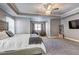 Large main bedroom featuring carpet, neutral walls, a bed, a ceiling fan, and sitting chairs at 4233 Creekrun Cir, Buford, GA 30519