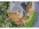 Aerial view of a single-story home featuring a well-maintained roof and landscaped yard surrounded by lush greenery at 620 Oakledge Nw Dr, Marietta, GA 30060