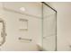 This bathroom features a glass enclosed shower with built in shelving and a neutral color palette at 620 Oakledge Nw Dr, Marietta, GA 30060
