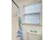 A bathroom featuring a shower with colorful shower curtain and a window with blinds at 620 Oakledge Nw Dr, Marietta, GA 30060