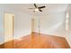 Bedroom featuring hardwood floors, white walls, a ceiling fan, and walk in closet at 620 Oakledge Nw Dr, Marietta, GA 30060