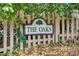 A weathered sign reading 'The Oaks', adding character to the entrance of the community at 620 Oakledge Nw Dr, Marietta, GA 30060