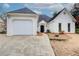 Inviting single-story home with a white painted brick and siding exterior and a well-manicured lawn at 620 Oakledge Nw Dr, Marietta, GA 30060