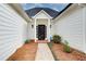 Inviting front entrance with a black front door, a white covered porch, and manicured landscaping at 620 Oakledge Nw Dr, Marietta, GA 30060