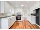 Bright kitchen featuring white cabinetry, stainless steel appliances, and hardwood flooring at 620 Oakledge Nw Dr, Marietta, GA 30060