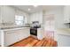 Bright kitchen with white cabinets, stainless steel appliances, hardwood floors, and an opening to the living room at 620 Oakledge Nw Dr, Marietta, GA 30060