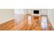 Bright living room featuring hardwood floors, a white fireplace, and large windows with plantation shutters at 620 Oakledge Nw Dr, Marietta, GA 30060