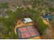 Aerial view showing tennis courts, swimming pool, playground, and surrounding wooded neighborhood at 4492 Bryten Dr, Douglasville, GA 30135