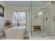 Bright bathroom with a soaking tub, a modern glass-enclosed shower, and stylish fixtures at 4492 Bryten Dr, Douglasville, GA 30135