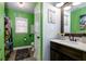 This green ' bathroom features dinosaur-themed wall decals and a shower curtain at 4492 Bryten Dr, Douglasville, GA 30135