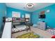 This bedroom has a bunk bed with a slide, a dresser with a television, and colorful decor at 4492 Bryten Dr, Douglasville, GA 30135