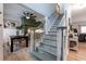 Welcoming foyer leading to the kitchen and living areas, with a staircase featuring wood and white accents at 4492 Bryten Dr, Douglasville, GA 30135