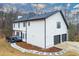 Rear exterior of home featuring a spacious deck and two-car garage, set in a wooded lot at 4492 Bryten Dr, Douglasville, GA 30135
