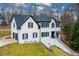 Stunning two-story home featuring a white brick facade, black shutters, and a well-manicured front yard at 4492 Bryten Dr, Douglasville, GA 30135