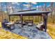 Outdoor gazebo featuring comfortable seating, stone flooring, and stylish lighting for relaxation at 4492 Bryten Dr, Douglasville, GA 30135