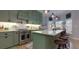 Modern kitchen with green cabinets, a large island, and stainless steel appliances at 4492 Bryten Dr, Douglasville, GA 30135