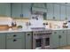 Beautiful kitchen with green cabinets, quartz countertops, and modern stainless steel appliances at 4492 Bryten Dr, Douglasville, GA 30135