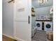 This laundry room boasts a sliding barn door and stacked front load washer and dryer at 4492 Bryten Dr, Douglasville, GA 30135