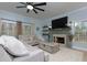 Cozy living room with a stone fireplace, plush seating, and ample natural light from multiple windows at 4492 Bryten Dr, Douglasville, GA 30135