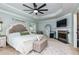 Tranquil main bedroom with a fireplace, tray ceiling, neutral tones, and ample natural light at 4492 Bryten Dr, Douglasville, GA 30135