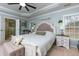 This main bedroom boasts light walls and tray ceiling plus a view into the en suite bathroom at 4492 Bryten Dr, Douglasville, GA 30135