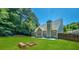 Large backyard with fire pit, wooden bench and fenced perimeter at 6196 Windflower Dr, Powder Springs, GA 30127