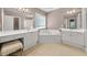 Bathroom boasts double vanity, corner soaking tub, and tile flooring at 6196 Windflower Dr, Powder Springs, GA 30127