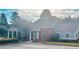 Charming clubhouse featuring a brick facade, covered porch, and well-maintained landscaping at 6196 Windflower Dr, Powder Springs, GA 30127
