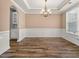 Formal dining room with chandelier and wainscoting at 6196 Windflower Dr, Powder Springs, GA 30127
