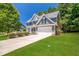 Green two-story house with a two-car garage and spacious lawn at 6196 Windflower Dr, Powder Springs, GA 30127