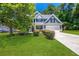 Two-story house with green siding, white trim, and a landscaped lawn at 6196 Windflower Dr, Powder Springs, GA 30127