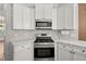 Modern kitchen with stainless steel appliances and white cabinetry at 6196 Windflower Dr, Powder Springs, GA 30127