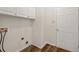 Bright laundry room with ample storage and a door to the outside at 6196 Windflower Dr, Powder Springs, GA 30127