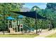 Fun playground with a shade structure, picnic tables, and plenty of space for to enjoy at 6196 Windflower Dr, Powder Springs, GA 30127