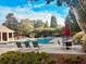 Resort-style pool with lounge chairs, lush landscaping, and inviting atmosphere at 6196 Windflower Dr, Powder Springs, GA 30127