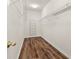 Large walk-in closet with wire shelving and wood flooring at 6196 Windflower Dr, Powder Springs, GA 30127