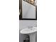 Bathroom with pedestal sink and framed mirror at 5667 Kingsport Dr, Atlanta, GA 30342
