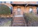 Townhouse entrance with brick steps and railing at 5667 Kingsport Dr, Atlanta, GA 30342