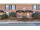 Brick townhouse exterior with landscaping and a walkway at 5667 Kingsport Dr, Atlanta, GA 30342
