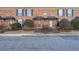 Brick townhouse exterior with landscaping and a walkway at 5667 Kingsport Dr, Atlanta, GA 30342