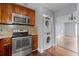 Kitchen with stainless steel appliances and laundry at 5667 Kingsport Dr, Atlanta, GA 30342