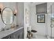 Modern bathroom with white tile, marble countertops, and a large mirror at 6870 Colfax Ave, Cumming, GA 30040