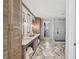 Elegant bathroom with double vanities, a large shower, and chevron patterned flooring at 6870 Colfax Ave, Cumming, GA 30040
