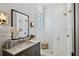 Spa-like bathroom with marble vanity, subway tile shower and gold fixtures at 6870 Colfax Ave, Cumming, GA 30040