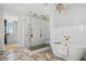 Modern bathroom with a freestanding tub, walk-in shower, and marble-look tile at 6870 Colfax Ave, Cumming, GA 30040