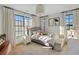 Bright bedroom with gray bed and white curtains, creating a serene atmosphere at 6870 Colfax Ave, Cumming, GA 30040